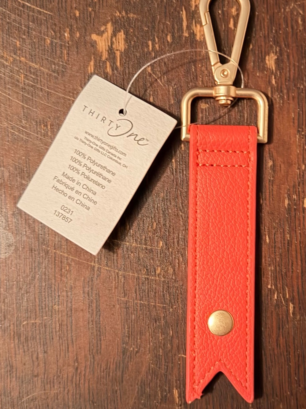thirty-one Cord Wrap Keychain in Coral with a Gold hardware clip